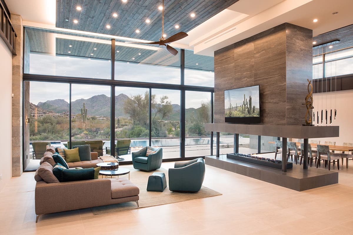 A wall of glass makes the Arizona desert the main focus of this home’s living room.