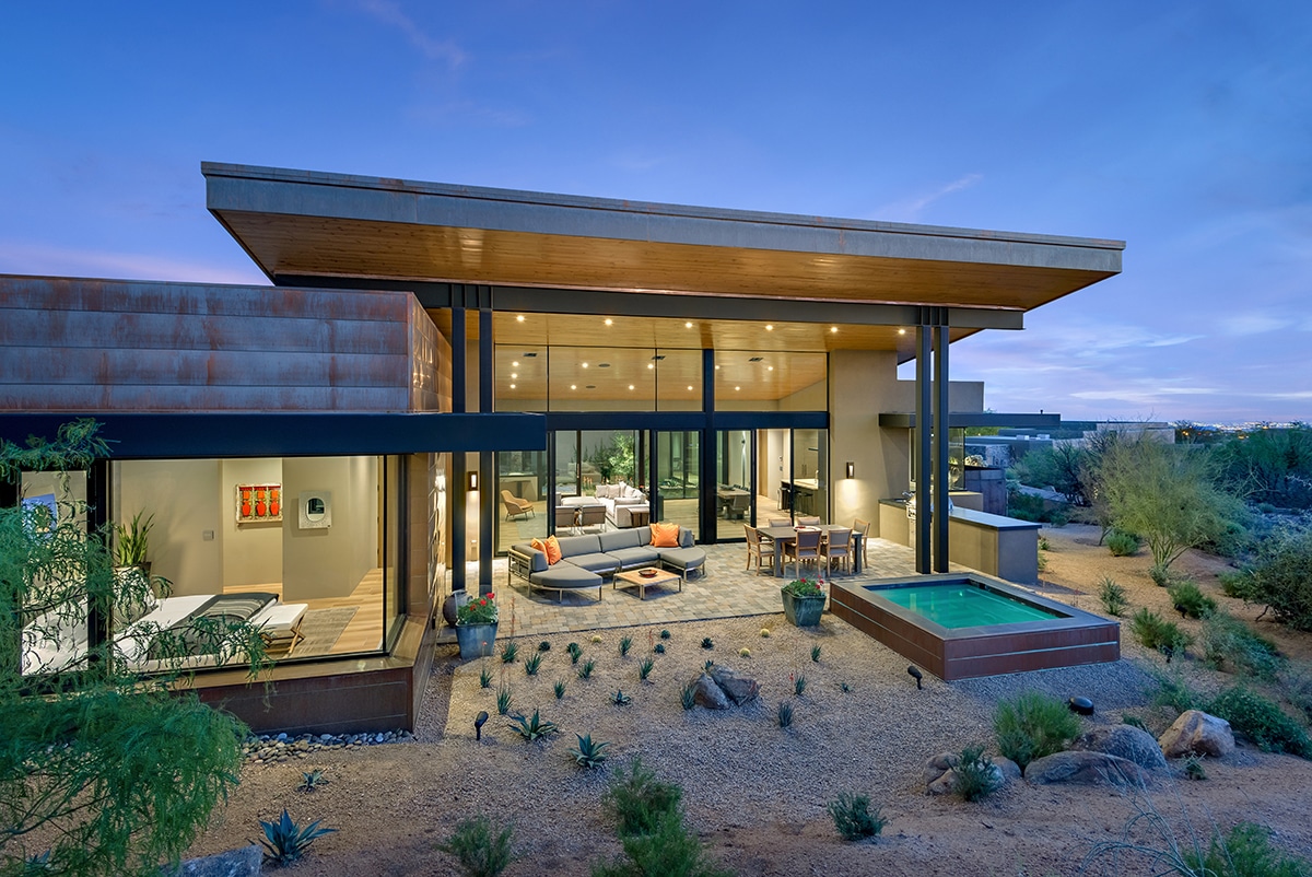 This desert home embraces the landscape with large glass panels that let views into the home and create an indoor-outdoor connection.