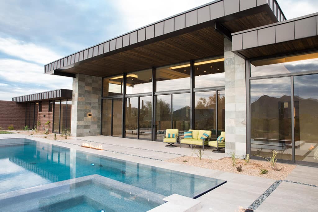 To capitalize on the desert landscape, architect Mark Sever went big with glass, incorporating floor-to-ceiling sliding patio doors leading to the backyard with a large pool.