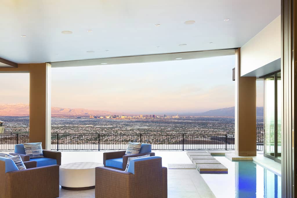 The walls of glass in this home completely disappear to provide uninterrupted views of Las Vegas.