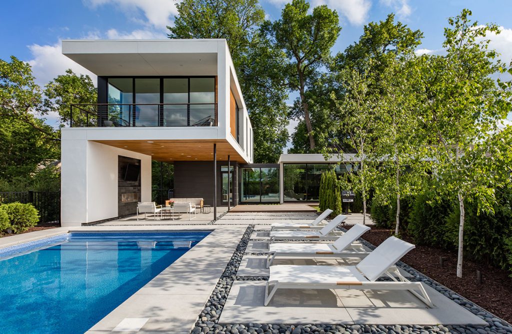 A view of the home’s backyard with a pool and outdoor seating area.