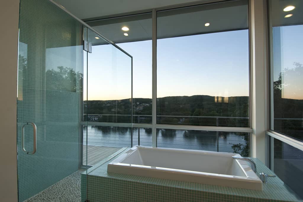 Giant walls of glass and a wrap-around balcony take soaking in the tub to a new level.