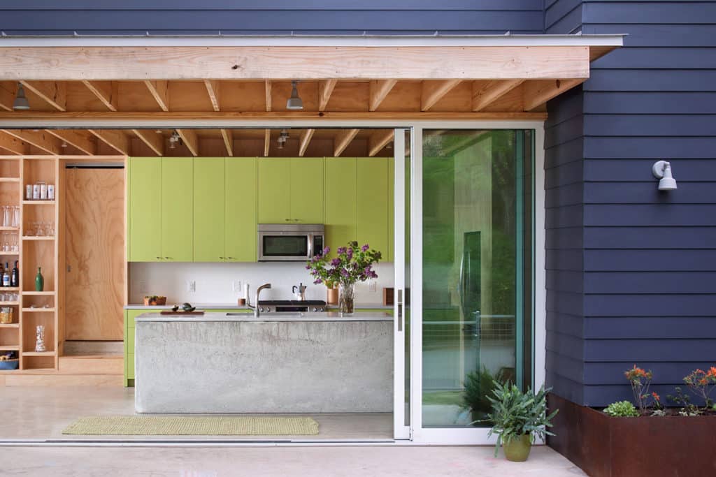 A huge Western Window Systems Series 600 Multi-Slide Door connects the wide-open kitchen with a sprawling back patio.