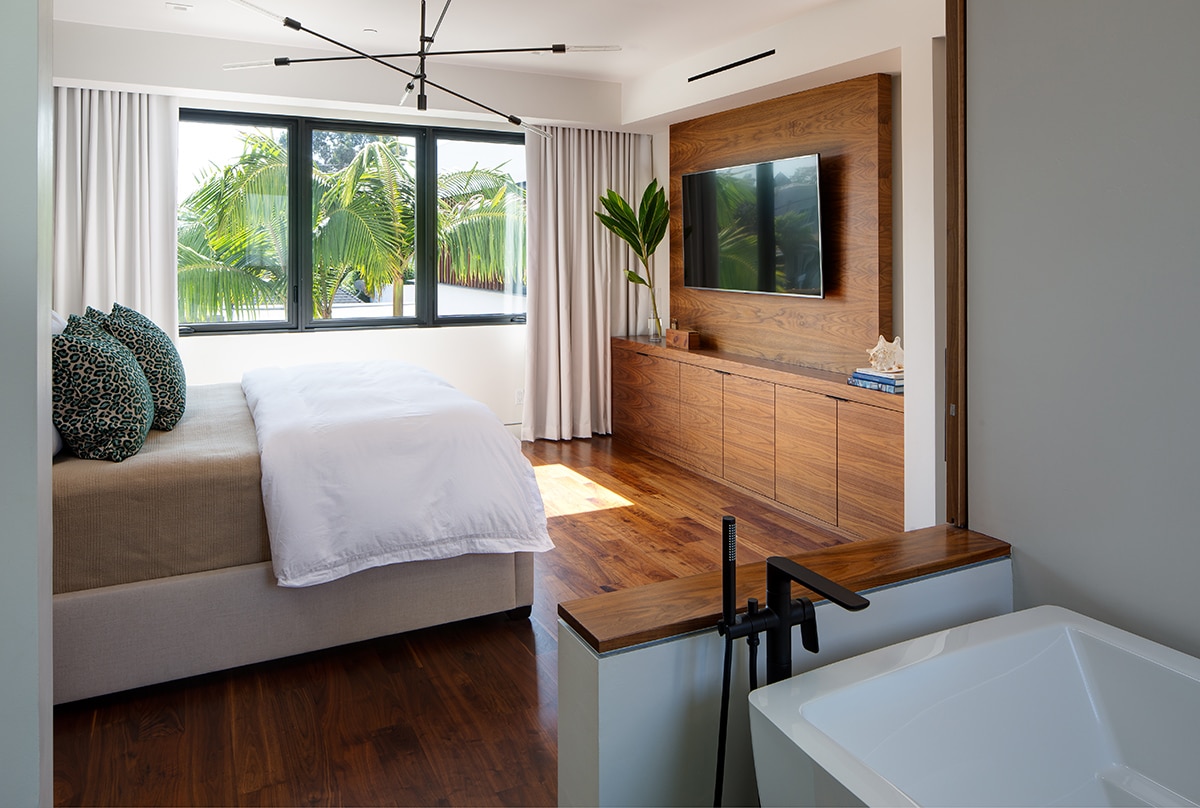 Casement windows swing open to let ocean breezes course throughout this bedroom.