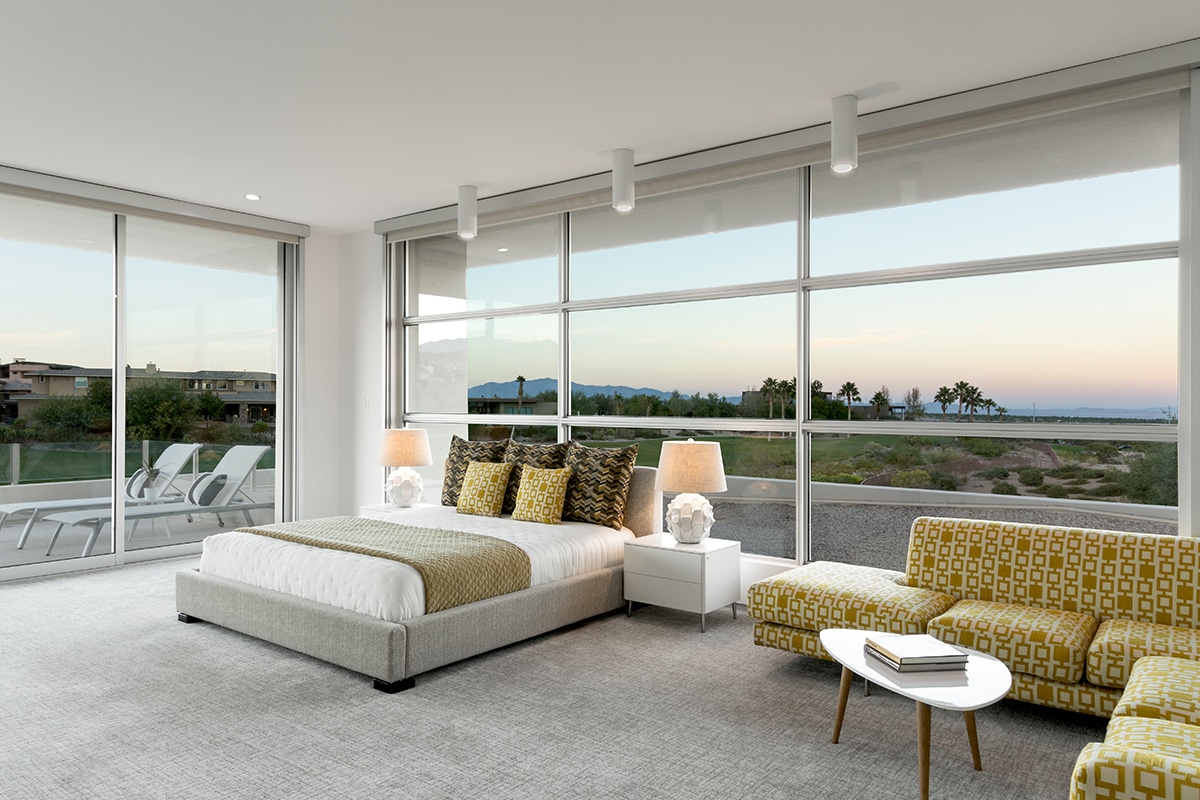A virtual wall of windows in the master suite surround the bed and provide beautiful views of the landscape.