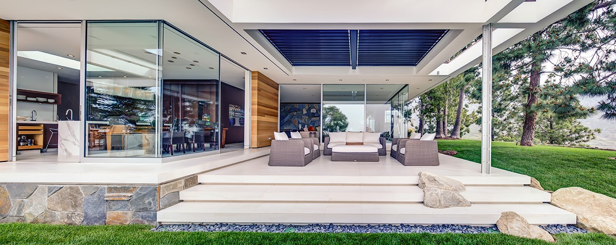 Slim profile, clean lines, and contemporary styling are all there with Western Window Systems’ multi-slide doors opening to an outdoor seating area.