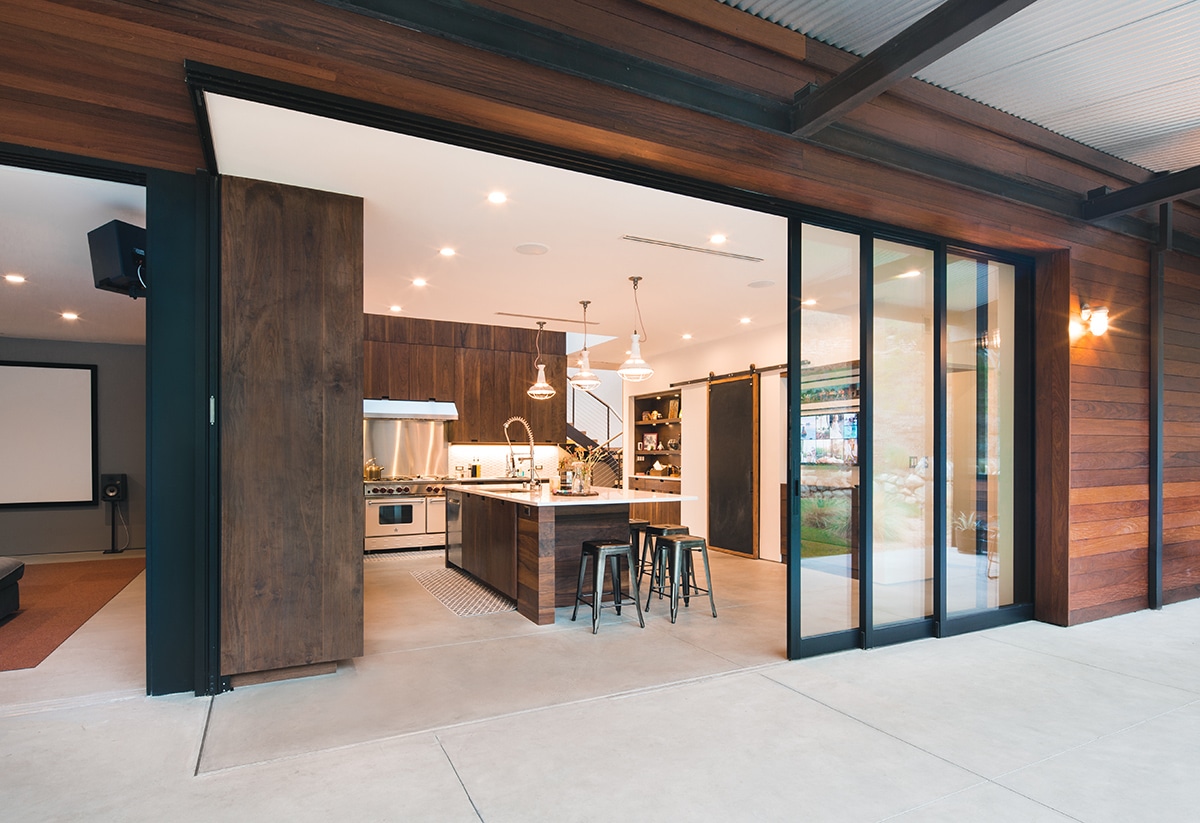 A massive Series 600 Multi-Slide Door seamlessly merges the kitchen with the back patio.