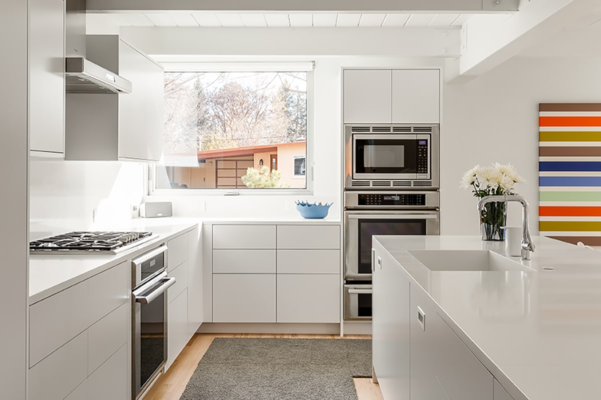 A large awning window provides tons of natural light for the mainly white kitchen.