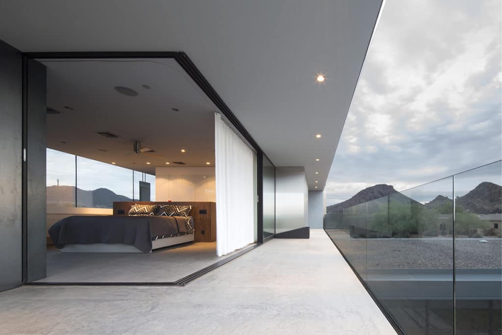 A pocketing 90-degree multi-slide door connects the bedroom to a balcony, creating a larger indoor-outdoor living space.