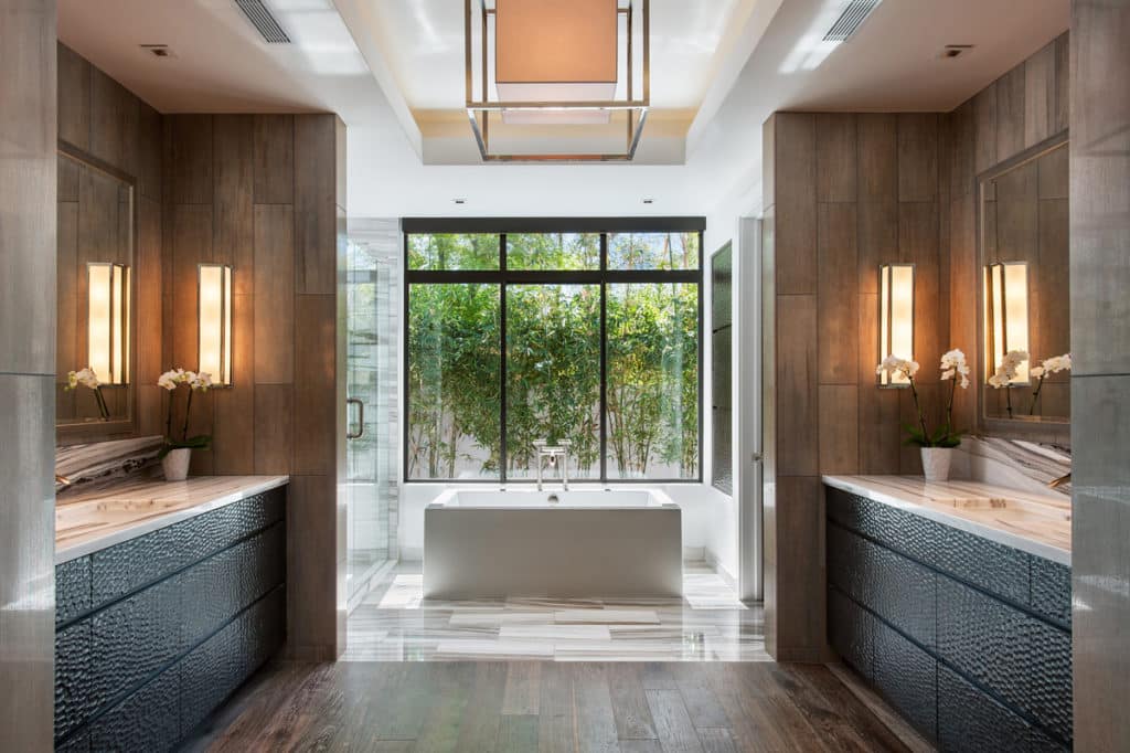 The elegant bathroom is complemented by the clean lines of Western Window Systems’ fixed windows behind the bathtub.