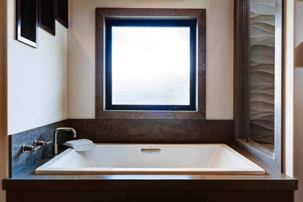 A frosted hinged window in the bathroom provides privacy when closed.