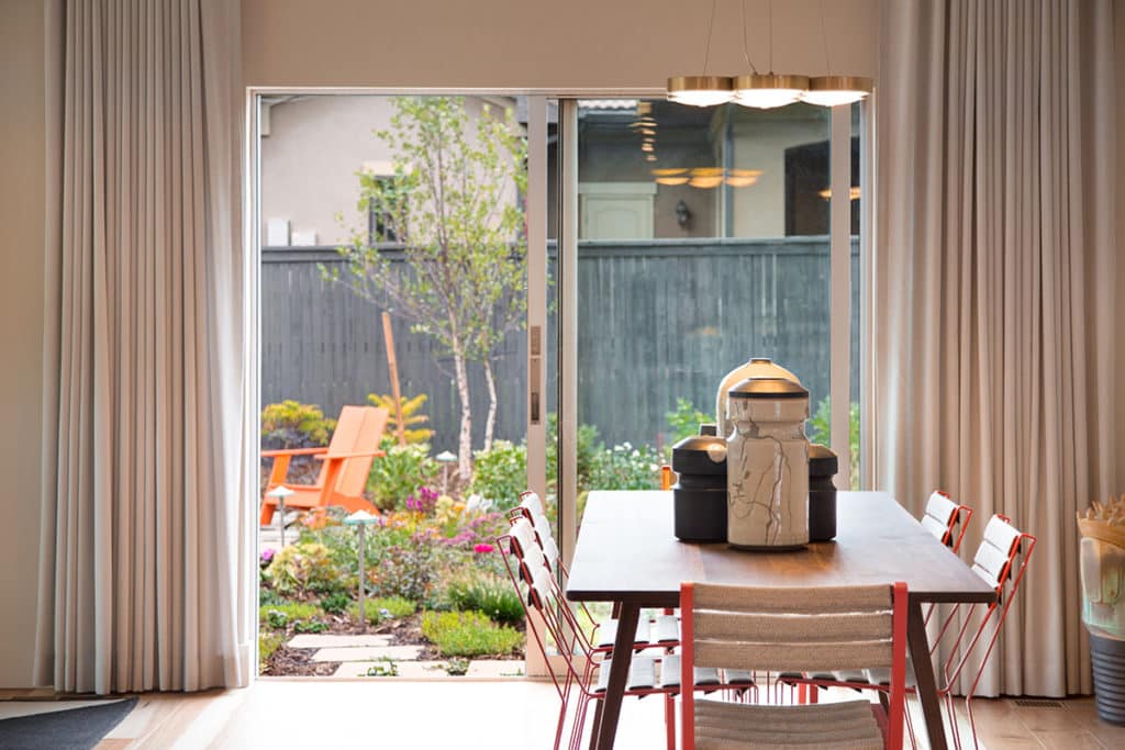 A sliding glass door opens the dining space to the lush backyard.
