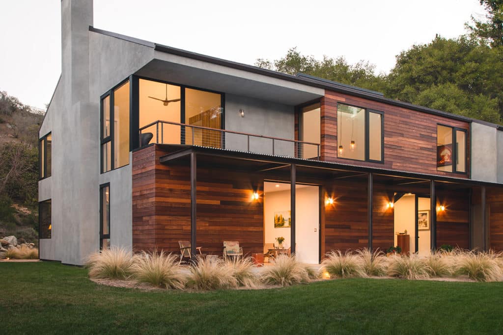 Sliding glass doors and large windows connect every room to the landscape.