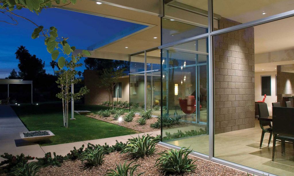 A home exterior nearly made of all glass walls.