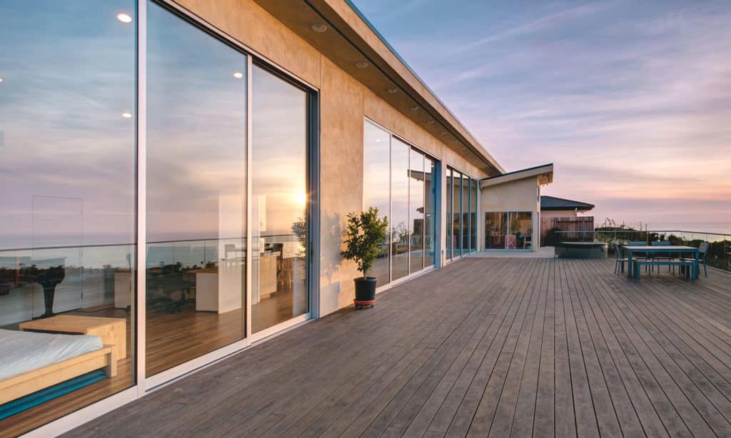 An image of a home with several closed aluminum multi-slide doors.