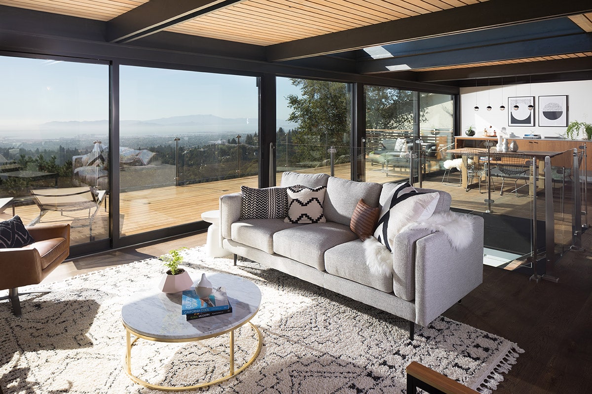 The upstairs living room connects to the balcony through a large sliding glass door.