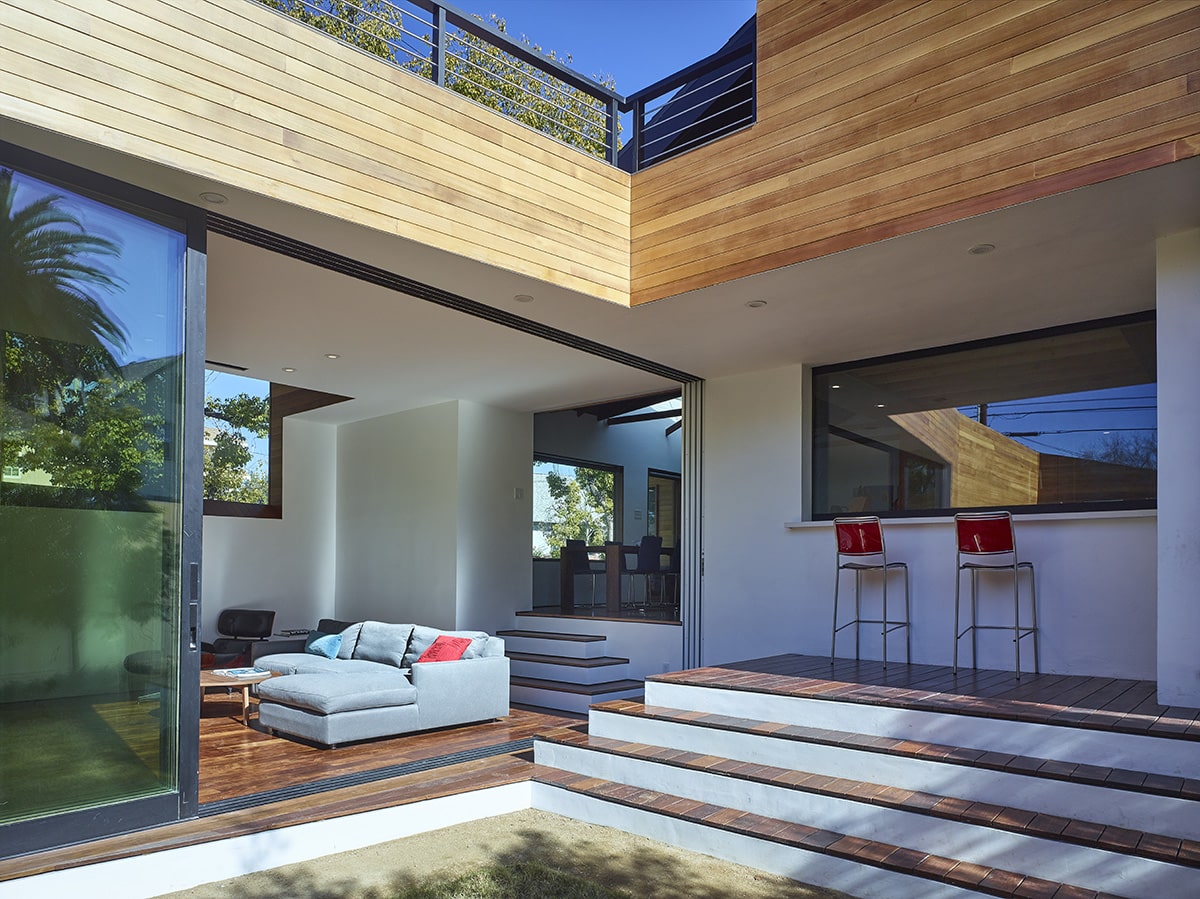 An open, sliding glass door gives living room an outdoor feel.