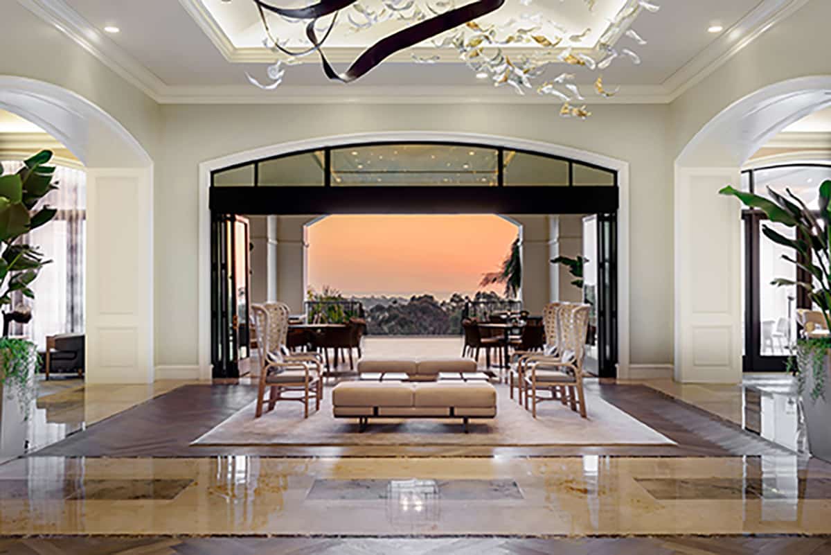 A massive bi-parting, bi-fold door opens the hotel lobby to the beautiful sunset outside.