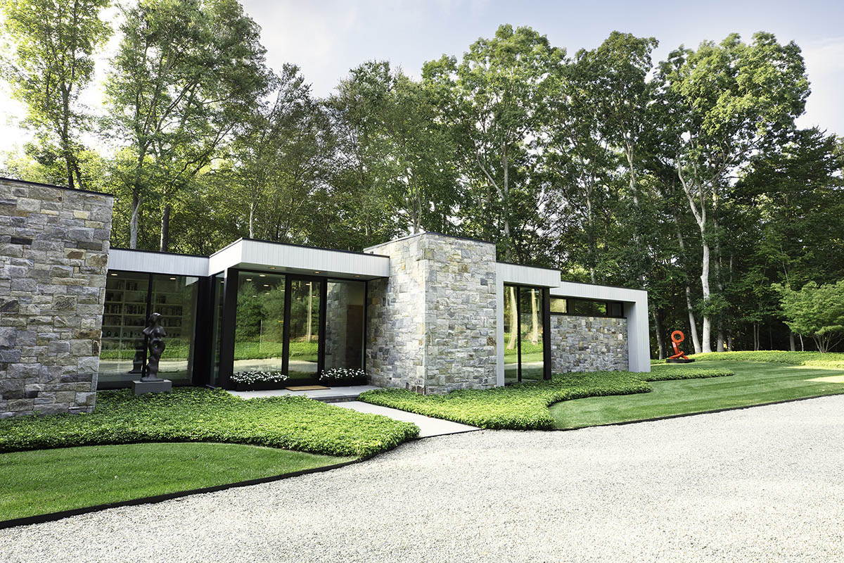 This modern home incorporates stone accents and large windows to blend and frame the surrounding landscape.
