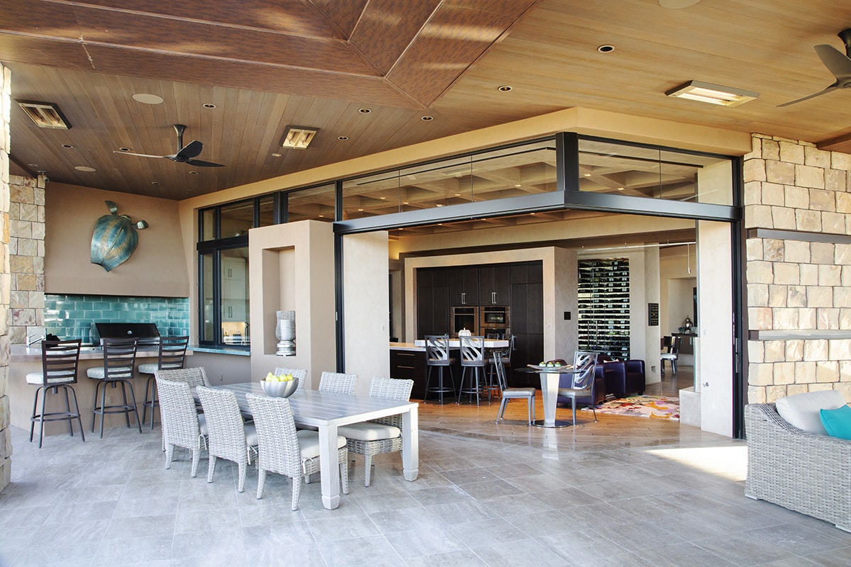 A 90-degree configuration of multi-slide doors creates an indoor-outdoor dining area.