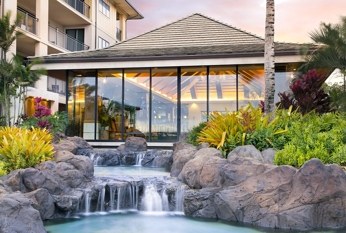 A beautiful view of multi-slide doors behind a small, man-made waterfall.