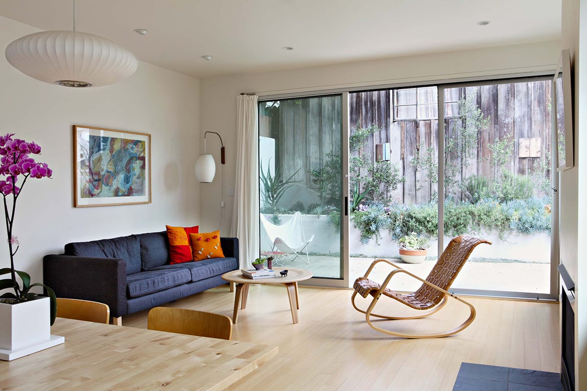 A large multi-slide door connects the living area to the Sant Monica backyard.