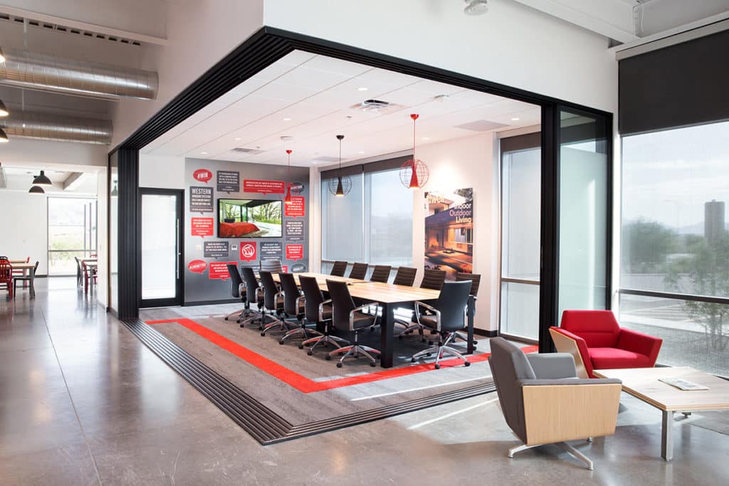 A 90-degree multi-slide door seamlessly merges this conference room with the Western Window Systems lobby area.