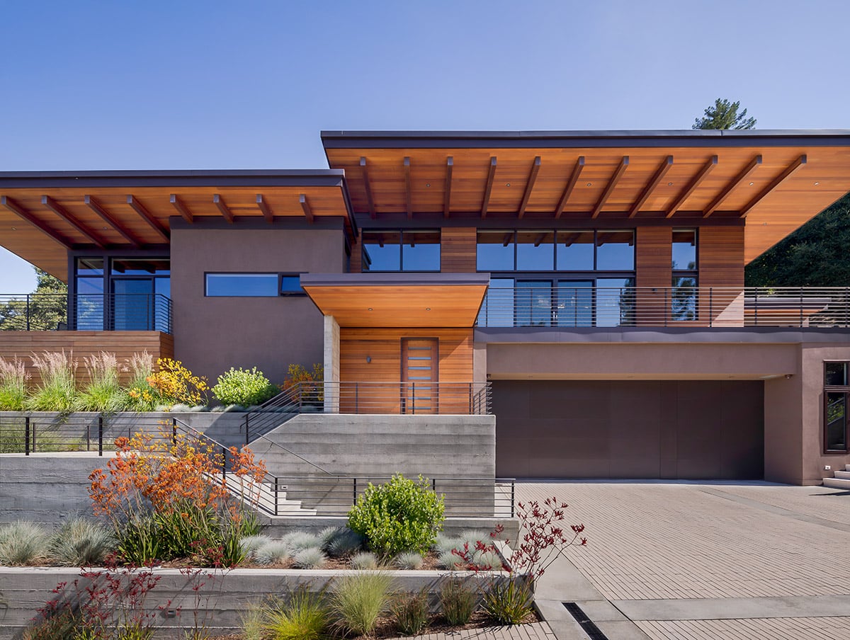 An impressive cedar ceiling and large expanses of glass highlight this stunning hillside home.