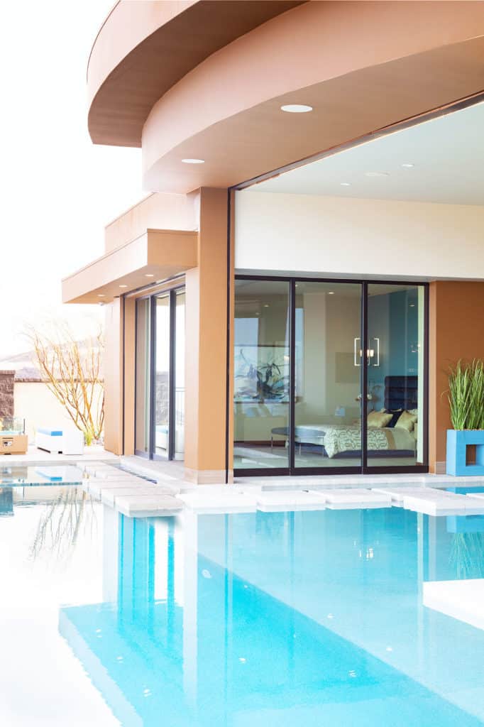 Two multi-slide doors meet 90-degrees at a connecting pillar.