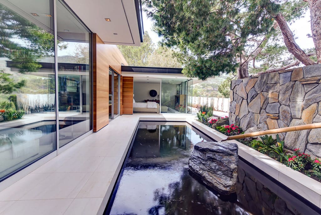 Large openings and panes of glass without connecting posts give homes a seamless connection between the indoors and the outside.