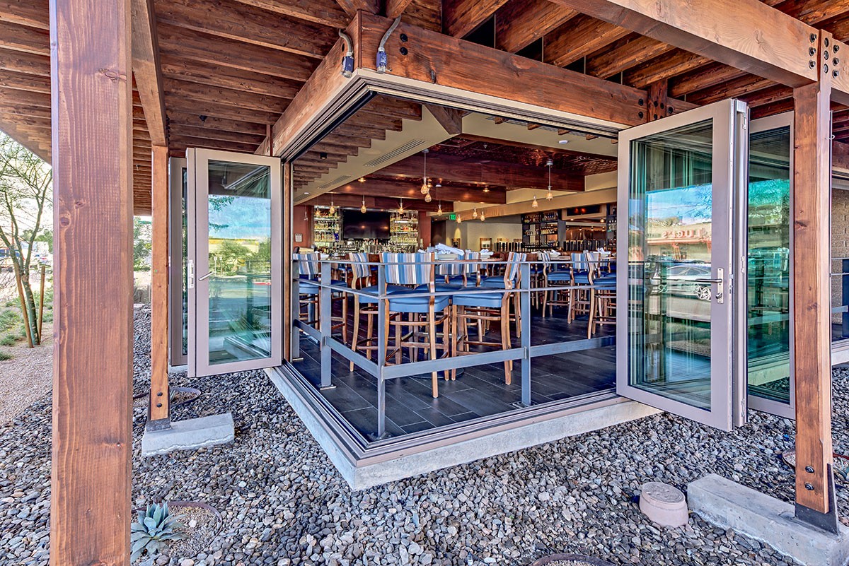 A 90-degree bi-fold door completely opens up the corner of the restaurant to the outdoors.