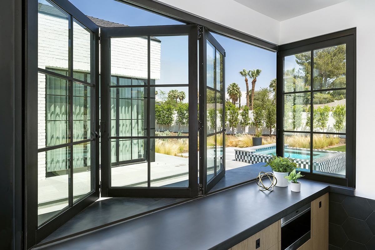 The Bi-fold windows over the kitchen bar lets guests outside enjoy an ice-cold beverage without having to go inside.