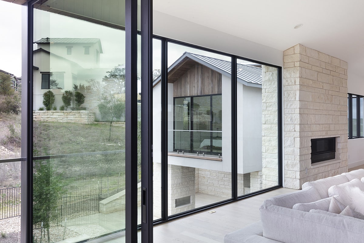 The high glass walls and door give a full view of the outside from the living room.