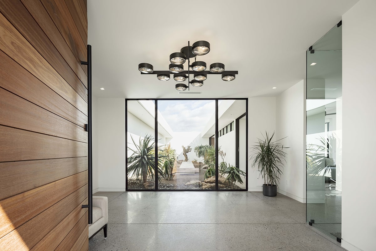 The glass-enclosed courtyard creates a mini micro-climate