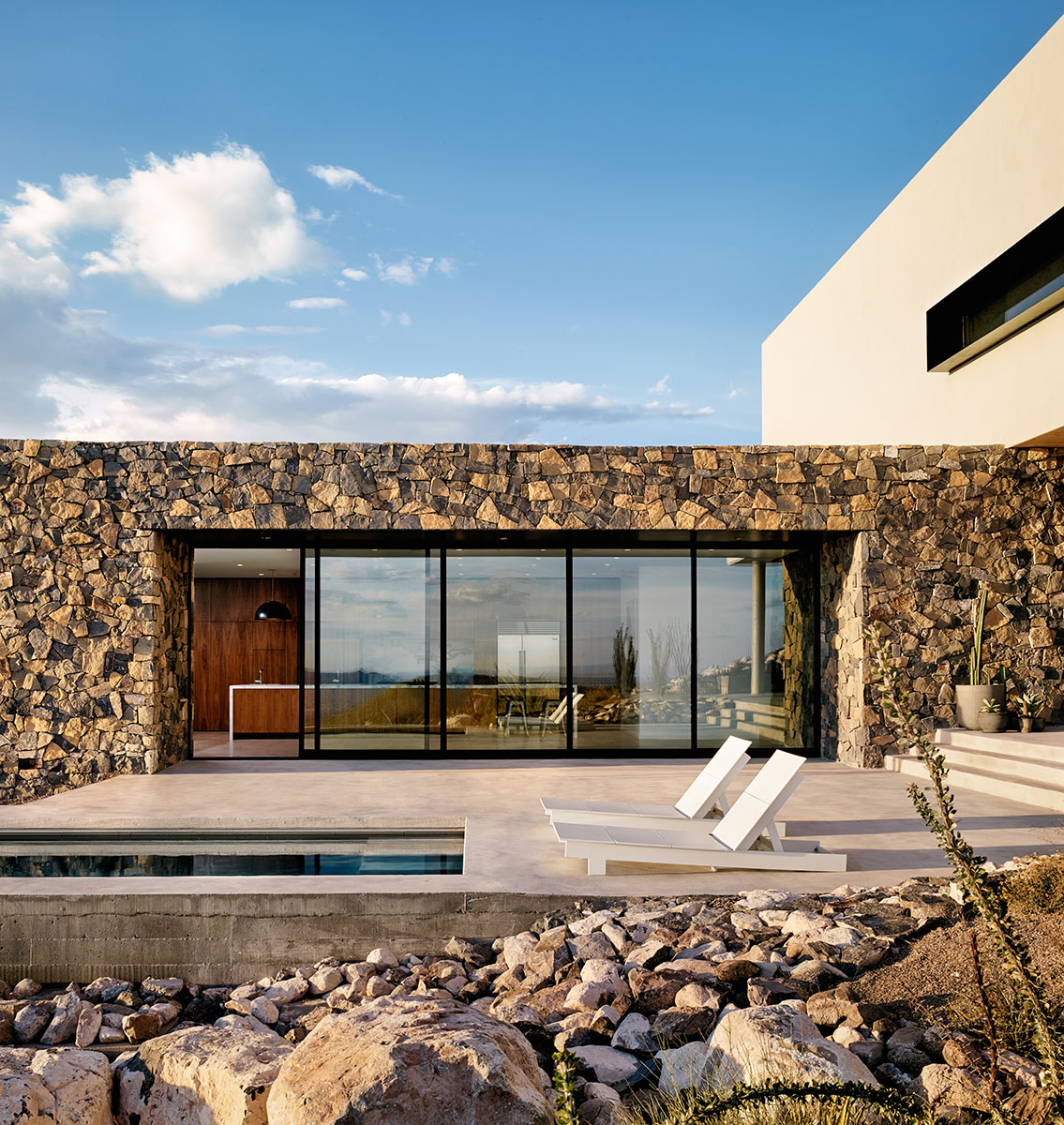 When the massive west-facing multi-slide door is open, cool Texas breezes course through the home's main volume.