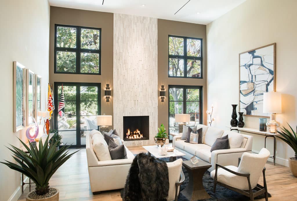 The fireplace is framed by Series 900 Hinged Doors and Series 670 hopper windows.