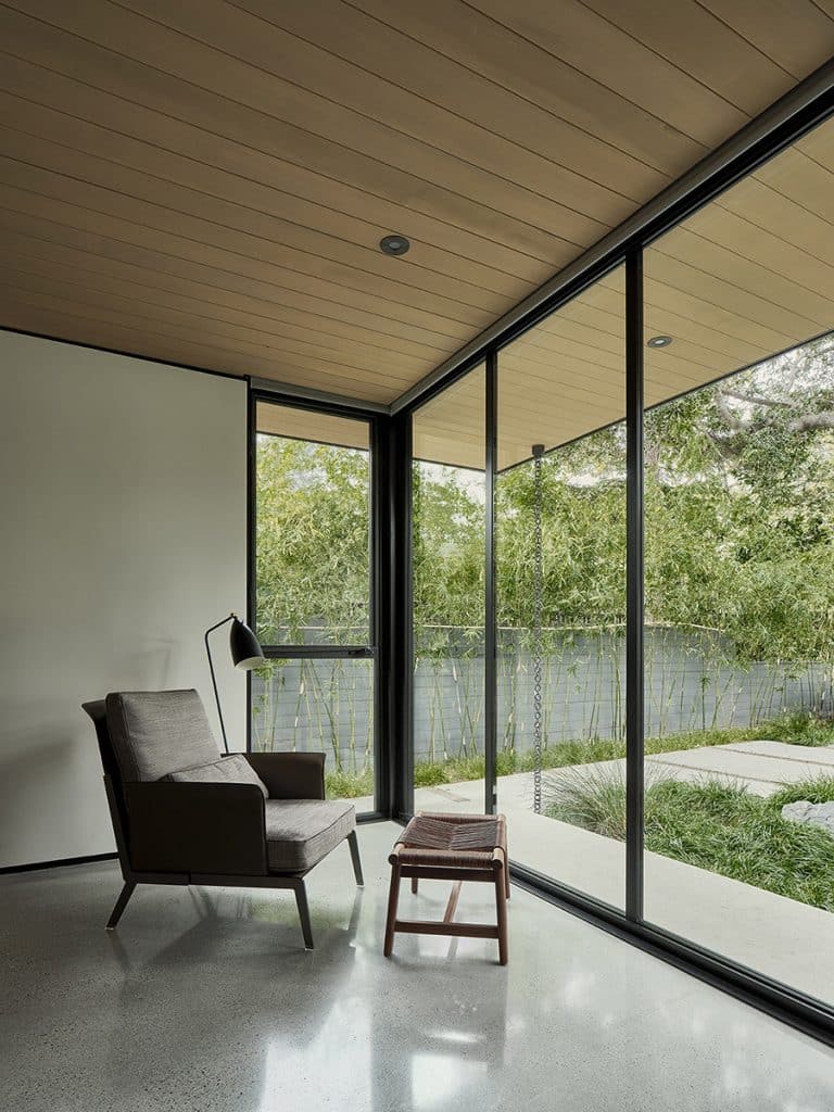 Floor-to-ceiling glass provides views of the century-old trees on the property.