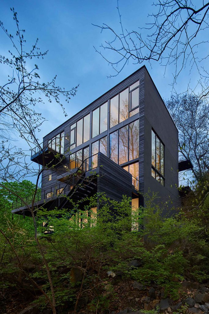 Four floors of wall-to-wall glass tower over the dramatic grade the house sits on.
