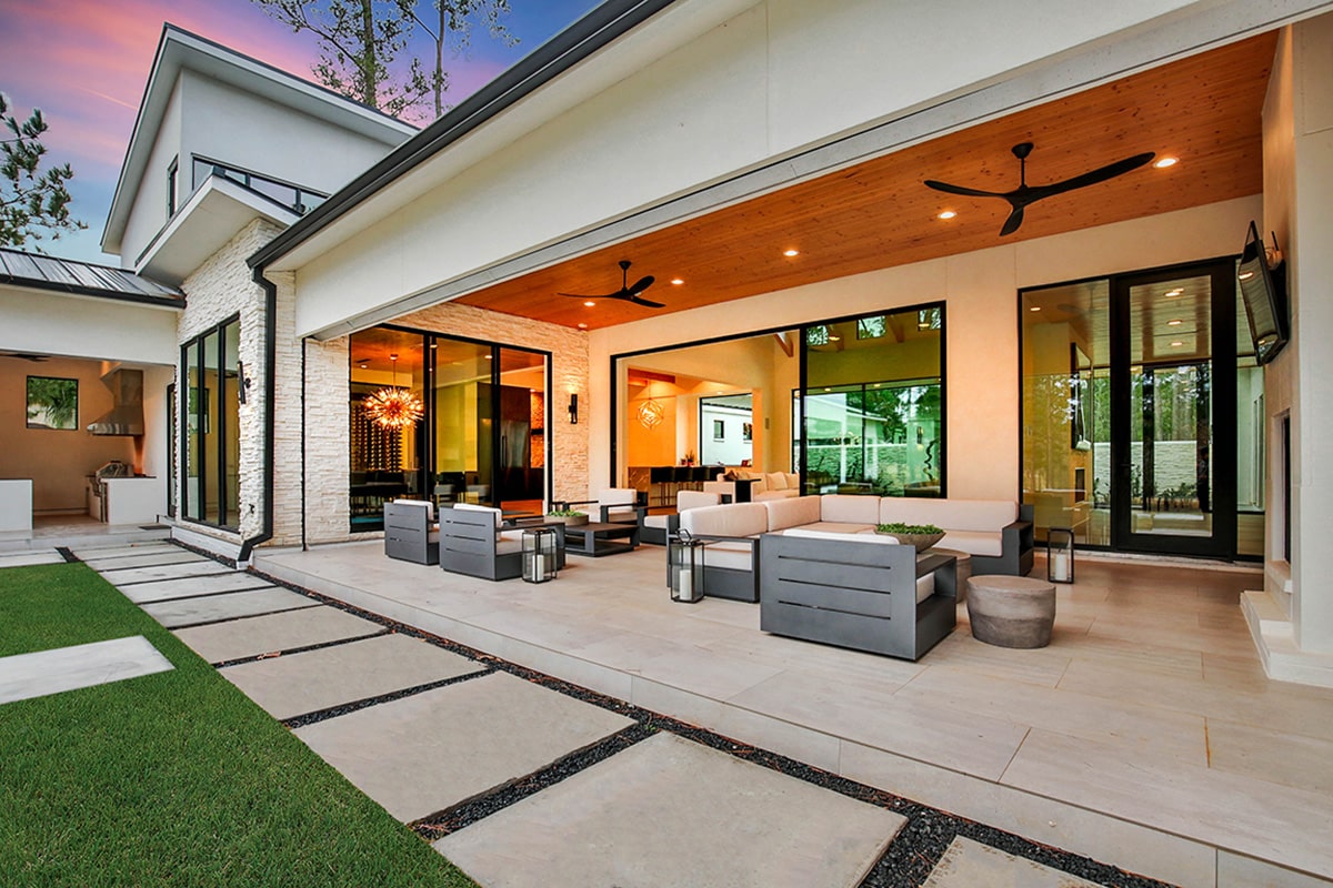 Multiple outdoor living areas are blended together for easy access through moving glass walls.