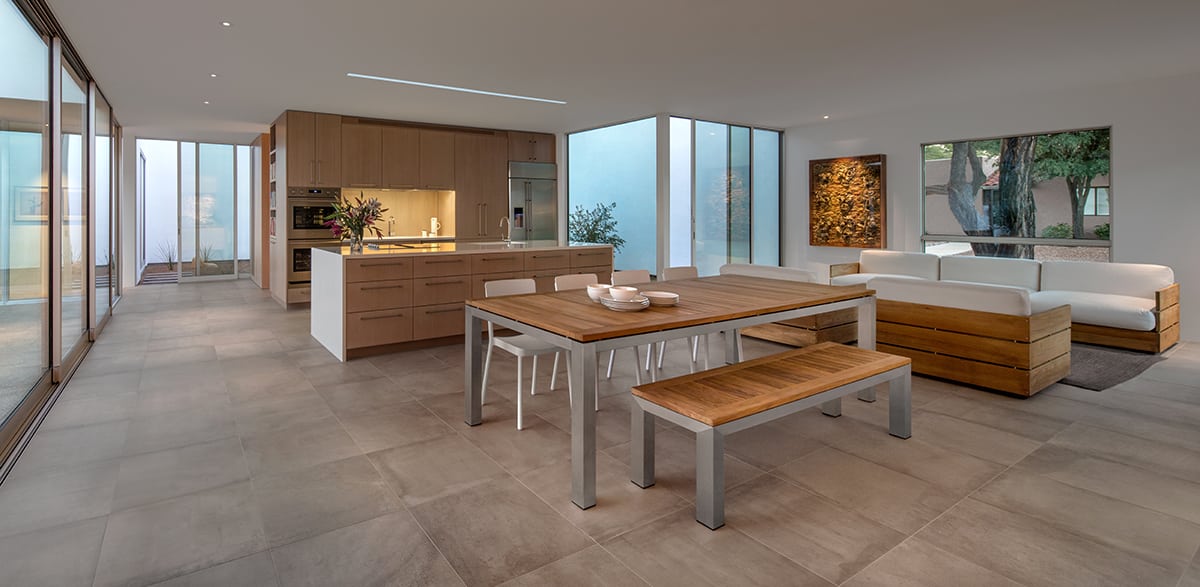 Huge panels of glass give the clients the ability to see into any number of the home’s courtyards at once from the kitchen, dining area, and living room.