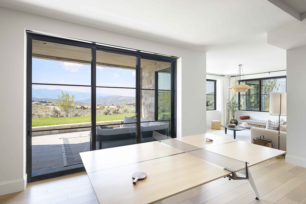 Rooms are filled with natural light while large windows shift focus to the outdoors.