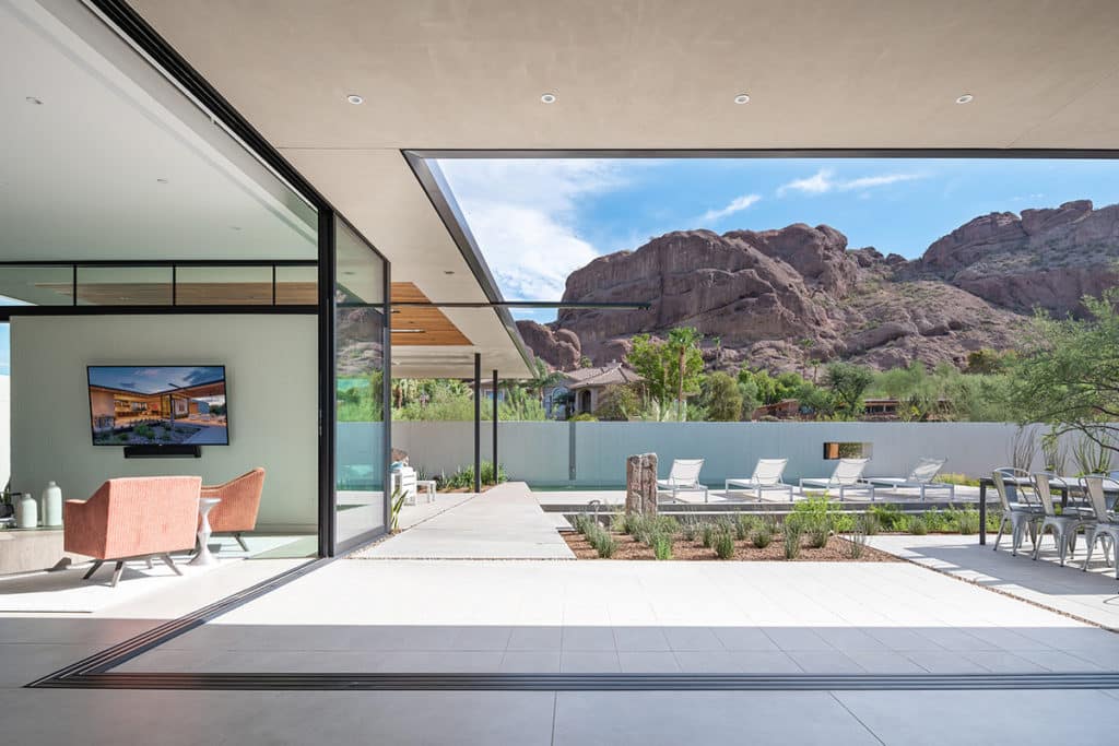The 90-degree, open corner multi-slide door seamlessly connects the living room to the patio while bringing mountain views into the home.