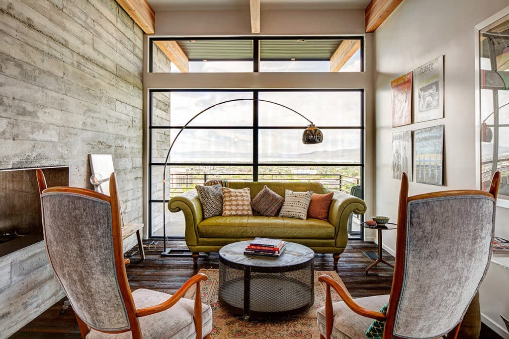 A large window brightens a small seating area.