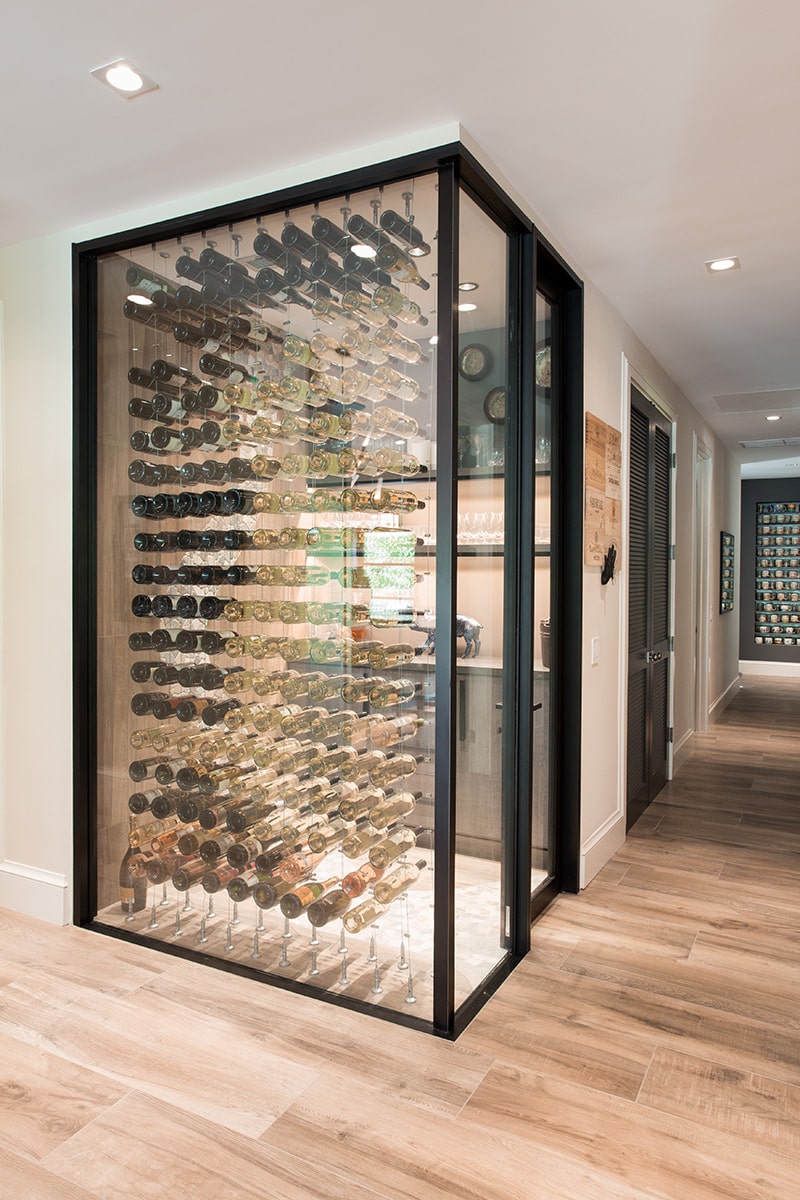 A glass-encased wine cellar is temperature-controlled at 57 degrees through energy efficient fixed windows and a hinged door.