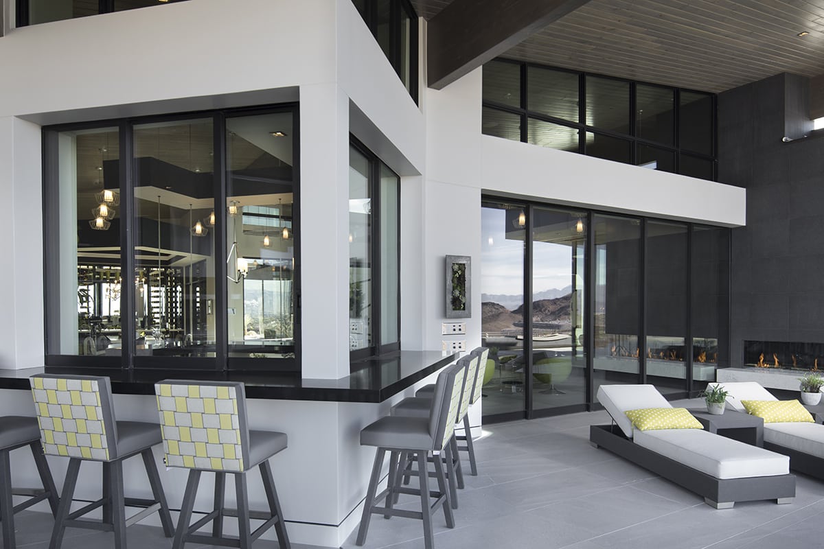 The back side of the home features an indoor-outdoor wet bar flanked on either side by huge Series 7600 Multi-Slide Doors.