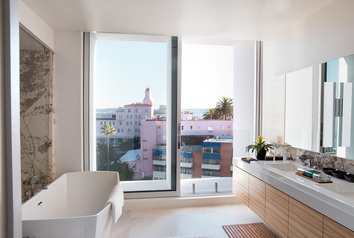 The bathroom also features a tall sliding glass door.