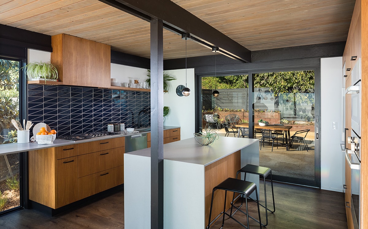 Sliding glass doors connect the kitchen to the outdoor patio space.