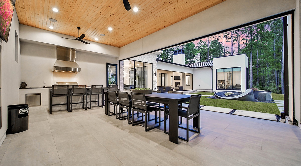 Multiple sliding glass walls and plentiful patios connect different areas of the house to each other outside.