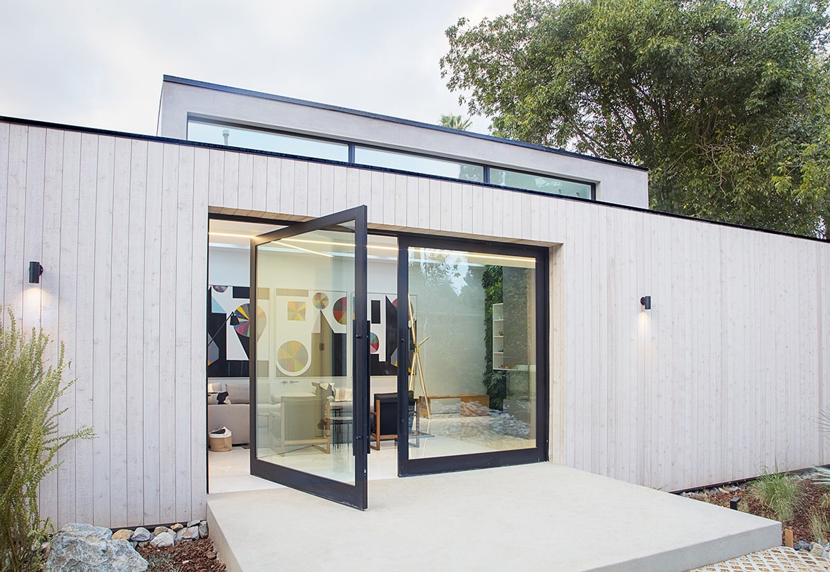 Double pivot doors spanning a 20-foot opening welcome visitors into the house.