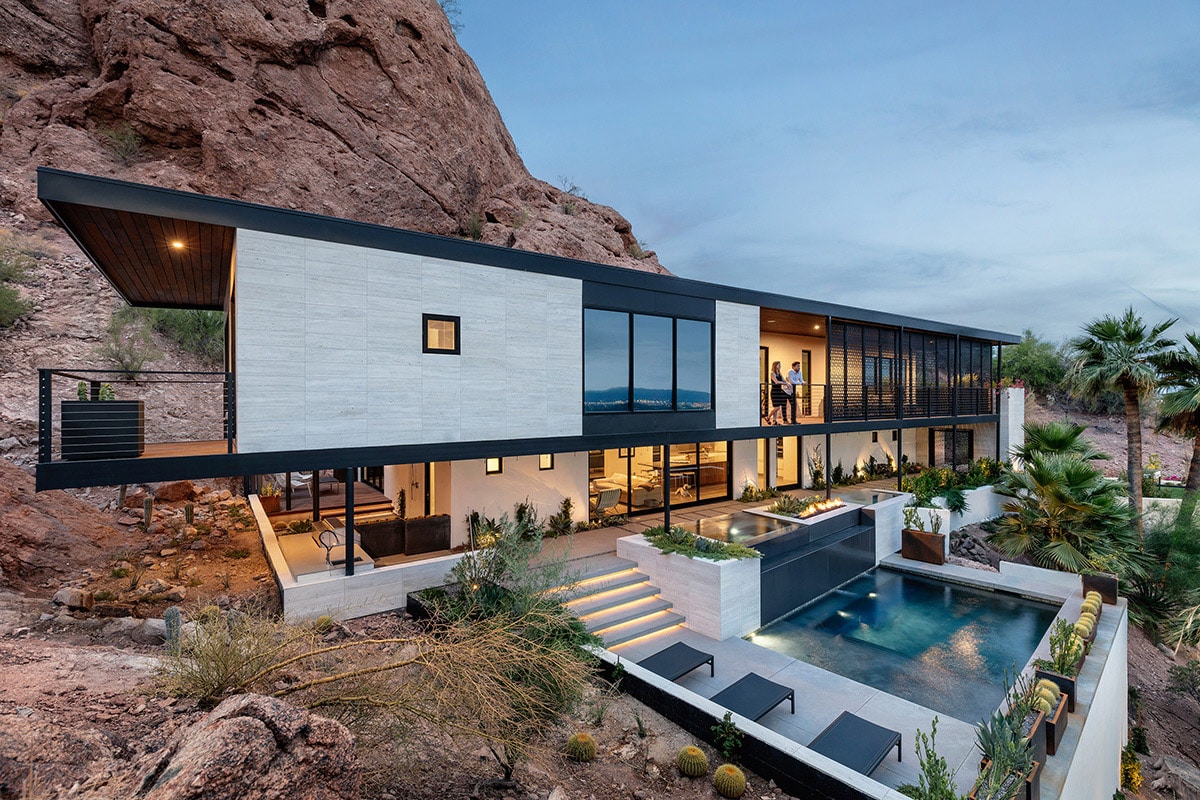 The stacking, multi-slide doors open rooms on both floors of the house to the outside patio and pool.